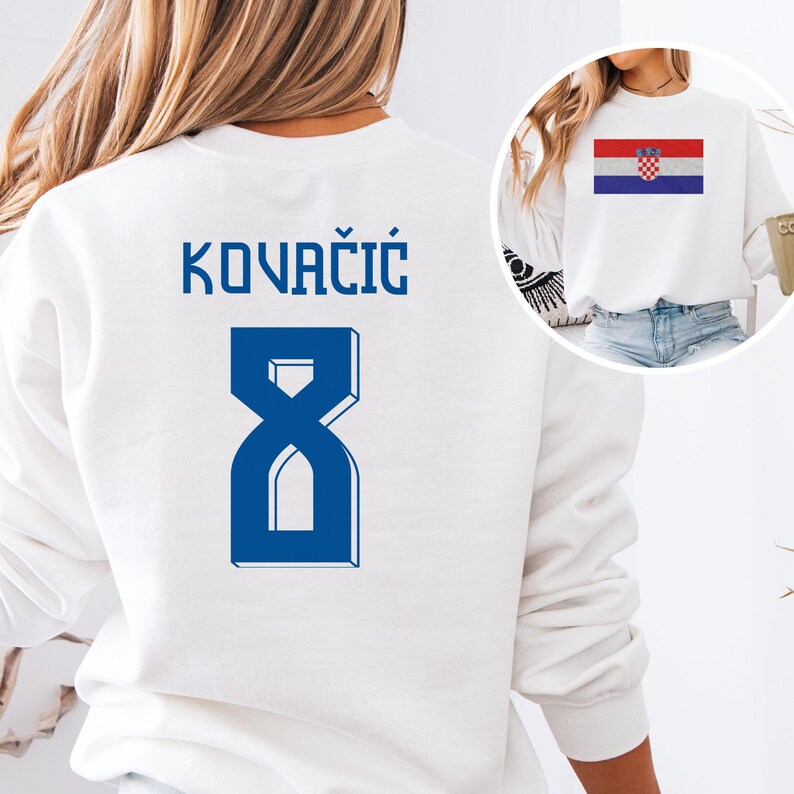 A white sweatshirt with the name 'KOVACIÓ' and the number '8' printed on it, along with a graphic of the national flag of Croatia.