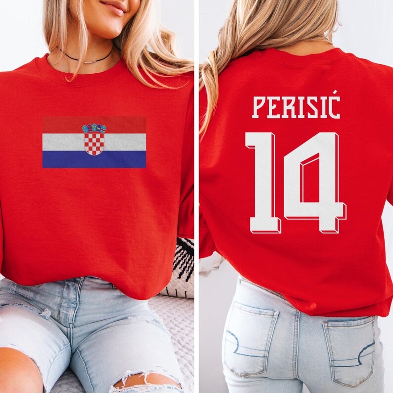 A woman wearing a red sweatshirt with the Croatia national flag and the number 14 printed on it.