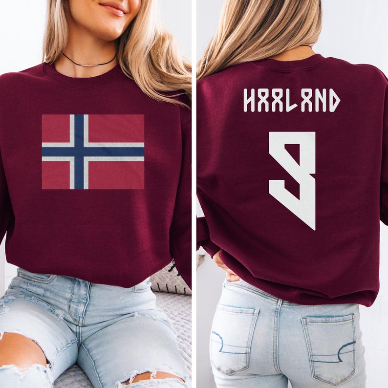 A woman wearing a burgundy sweatshirt with the flag of Norway and the number 9 on the back.