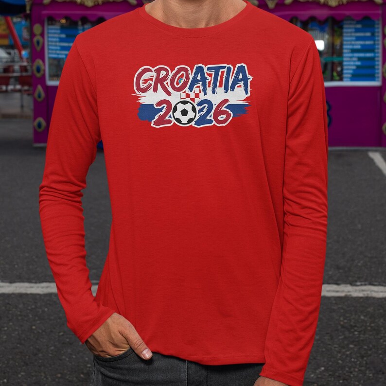A person wearing a red long-sleeved shirt with the text "GROATIA 1996" printed on it.