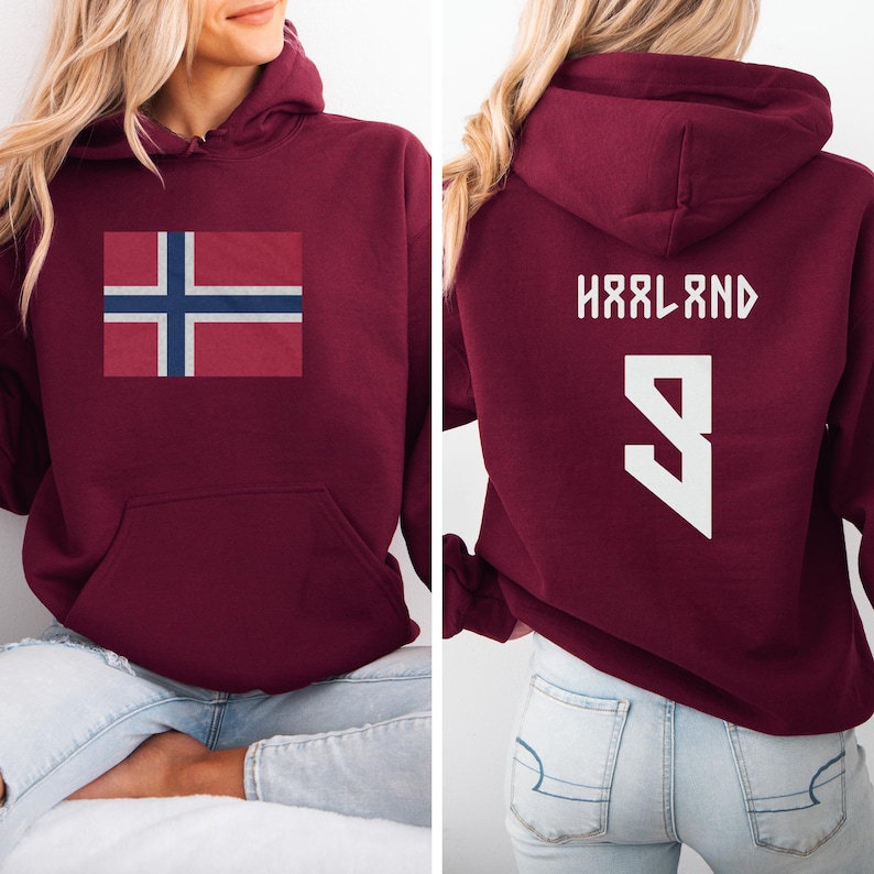 A woman wearing a burgundy hoodie with the flag of Norway and the number 9 on the back.