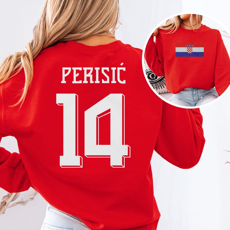 A woman wearing a red sweatshirt with the number 14 and the word "PERISIC" printed on it.