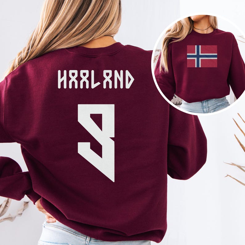 A woman wearing a burgundy sweatshirt with the name 'Hålnd' and the number '9' printed on it.