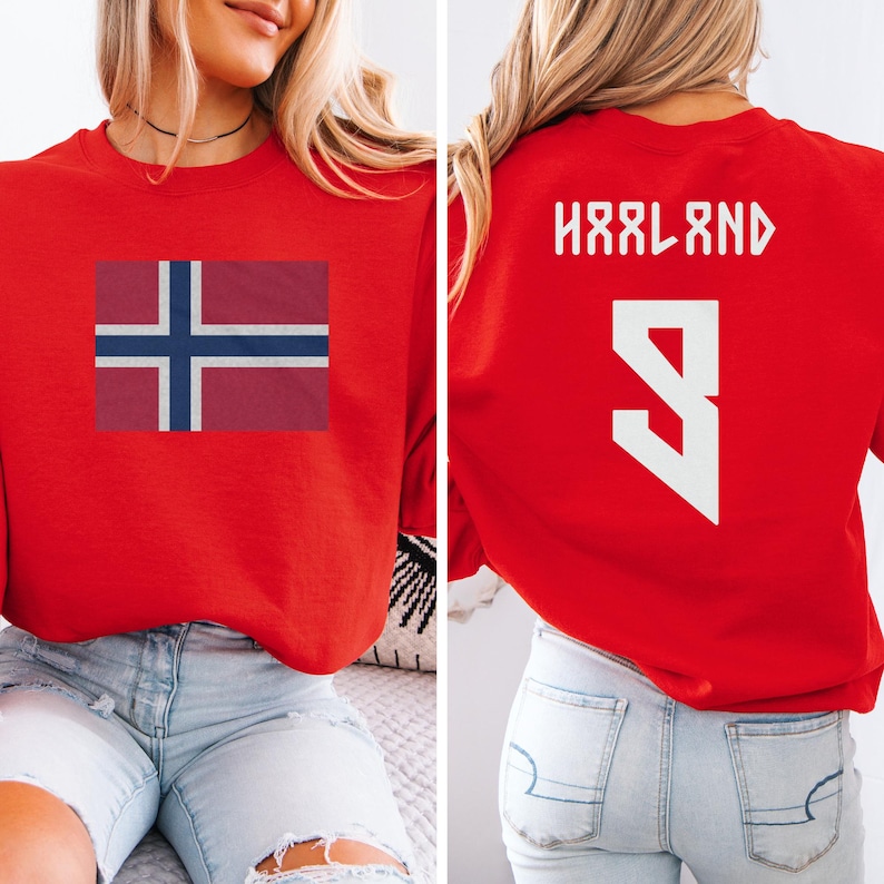 A woman wearing a red sweatshirt with the flag of Norway and the number 9 on the back.