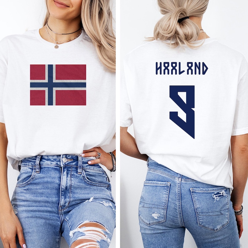 A woman wearing a white t-shirt with the flag of Norway and the number 9 on the back, along with blue jeans.