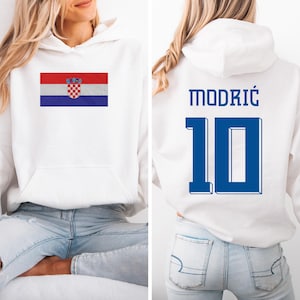 A woman wearing a white hoodie with the Croatia national flag and the number 10 on the back.