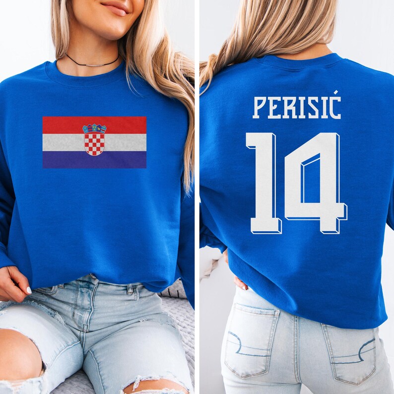 A woman wearing a blue sweatshirt with the Croatia national flag and the number 14 printed on it.
