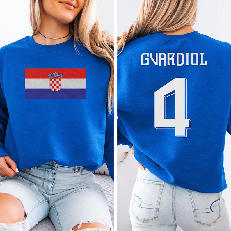 A woman wearing a blue sweatshirt with the Croatia national flag and the number 4 printed on it.