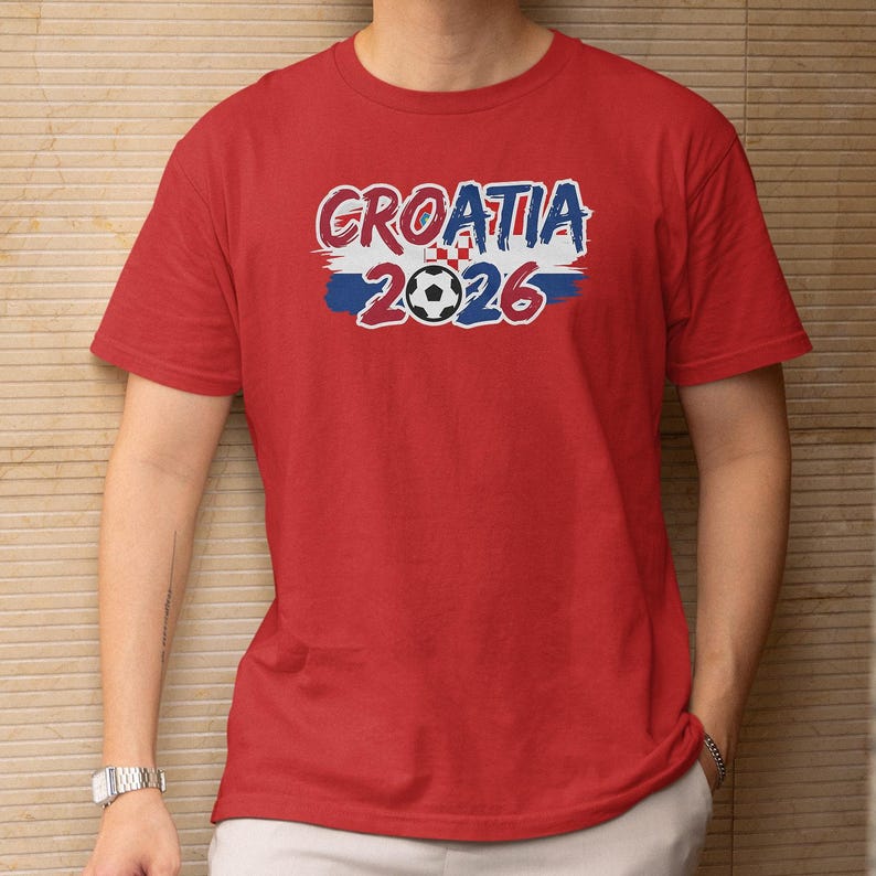 A red t-shirt with the text "GROATIA 2026" printed on it, along with a soccer ball graphic.