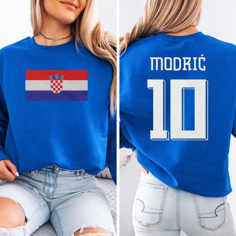 A woman wearing a blue sweatshirt with the Croatia national flag and the number 10 printed on it.