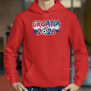 A red hoodie with the text "Croatia 2026" printed on it.