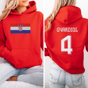 A woman wearing a red hoodie with the Croatia national flag and the number 4 on the back.