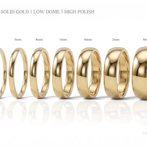 May include: A collection of gold wedding bands in various widths, from 2mm to 8mm, displayed on a white surface. The rings are labeled with their sizes and the text "10K SOLID GOLD | LOW DOME | HIGH POLISH". The rings have a high-polish finish.