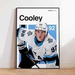 May include: A hockey player wearing a white jersey with blue and black accents, a white helmet with a black visor, and black hockey pants. The player is holding a black hockey stick. The jersey has the number "92" on the front and back. The player's name "Cooley" is printed in black at the top of the image.