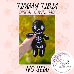 May include: A black and white crochet skeleton doll with the text "TIMMY TIBIA DIGITAL DOWNLOAD" and "NO SEW". The doll is held in a hand against a blurred green and yellow background. The doll has white accents and a skeleton design.