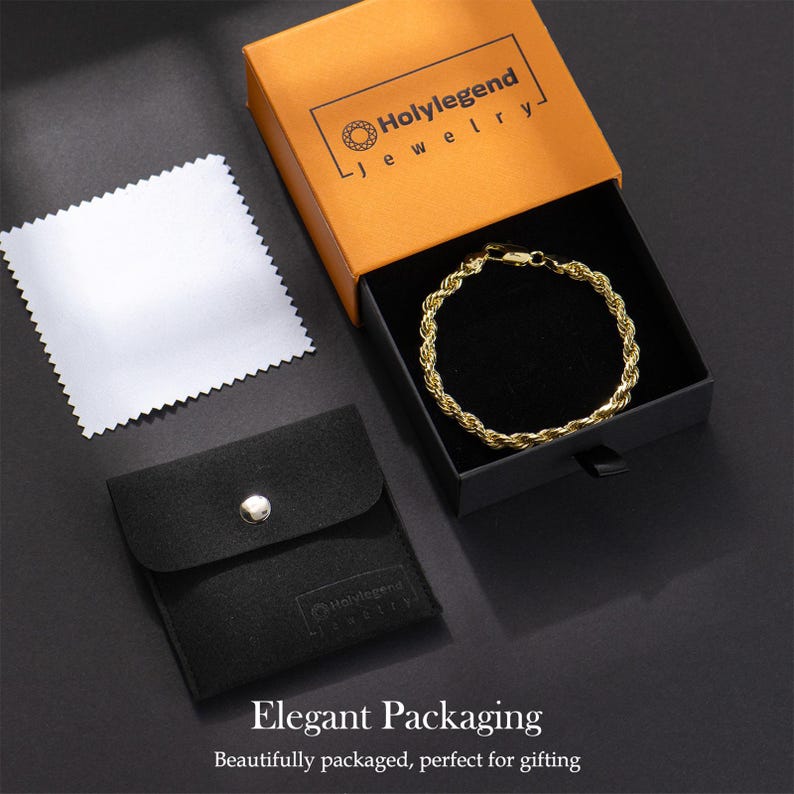 May include: A gold-colored rope chain bracelet displayed in an orange and black gift box. The box is branded with the text "Holylegend jewelry". A black pouch and a silver polishing cloth are also present. The words "Elegant Packaging" are at the bottom.