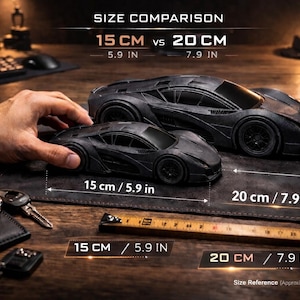 May include: Two black toy sports cars, 15 cm (5.9 in) and 20 cm (7.9 in) long, are displayed on a dark surface. A Coca-Cola can is used for size comparison. The image includes a watch, keys, and a ruler.