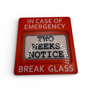 May include: A red rectangular sign with white text reading "IN CASE OF EMERGENCY" and "BREAK GLASS". The centre section displays "TWO WEEKS NOTICE". A humorous novelty item.