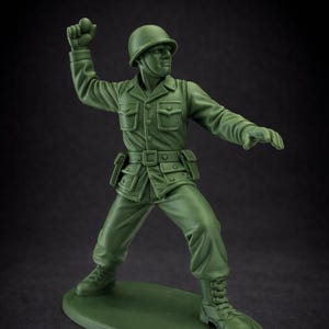 May include: A white ceramic mug with a black handle and the text "But First, Coffee" in a bold, black font. The mug is set against a neutral background, highlighting its simple design.