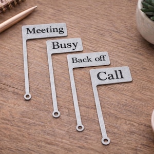 May include: A set of three ceramic mugs with a speckled, matte finish. Each mug features a different color: light blue, cream, and gray. The mugs have a simple, modern design and a comfortable handle.