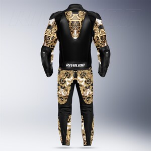 May include: Black and gold motorcycle racing suit with decorative patterns. The suit has a black leather upper body and legs, with gold and white baroque-style designs on the sleeves and lower legs. The text "RIVALION" is printed on the back.
