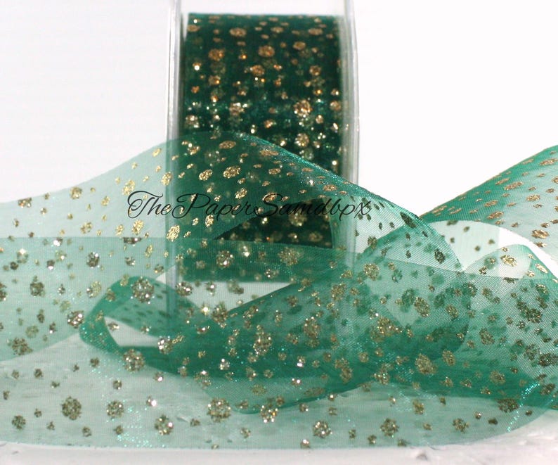 May include: A roll of emerald green ribbon with gold glitter spots. The ribbon is transparent and has a delicate texture. The Paper Samdbp text is visible on the ribbon. Suitable for crafts, gift wrapping, and decorations.