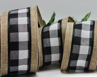May include: A roll of decorative ribbon featuring a black and white buffalo check pattern. The ribbon has a tan burlap-like edge and is suitable for crafts, gift wrapping, and home decor projects.