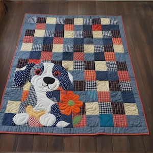 May include: A patchwork quilt featuring a smiling dog applique with blue polka dot ears and a flower. The quilt has a blue, red, and cream checkered pattern, with a red border. The quilt is approximately 48 inches by 60 inches.