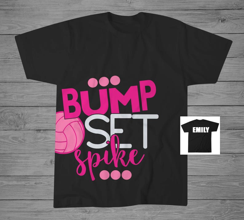 May include: Black t-shirt with the text "Bump Set Spike" in pink and white letters. A pink volleyball is included in the design. The text "Emily" is on a separate black t-shirt.