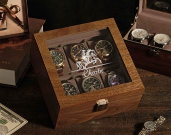May include: A wooden watch box with a glass lid featuring a white graphic of a horse and the name Charlie. The box has six interior compartments, each containing a wristwatch. A metal latch secures the front of the box.