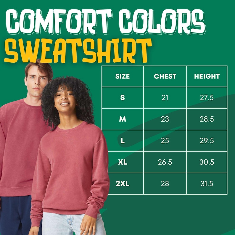 Puede incluir: Dos personas modelan una sudadera Comfort Colors de color granate. La imagen incluye una tabla de tallas con medidas de pecho en pulgadas y medidas de altura en pulgadas para las tallas S a 2XL. El texto "COMFORT COLORS SWEATSHIRT" est&aacute; en la parte superior.