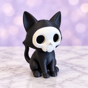 May include: A 3D printed figurine of a black cat wearing a white skull mask. The cat is in a seated position with pointed ears, a curved tail, and large, hollow eye sockets. The surface of the object shows visible horizontal layer lines.