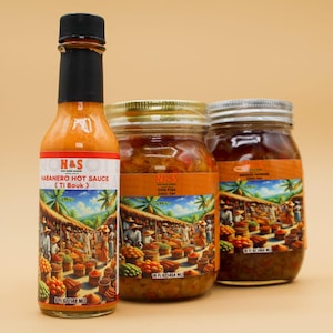 May include: Three glass jars of N&S West Indies Goodies. The jars contain orange and red sauces. The jars have a colorful label with a scene of a market. The label also says "N&S" and "West Indies Goodies". There is also a small bottle of N&S Habanero Hot Sauce (Ti Bouk).