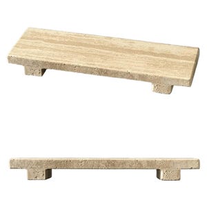 May include: A rectangular beige travertine stone riser with a porous, natural texture. The platform features a flat top surface supported by two small, block-shaped feet at each end, providing a slightly elevated display base for various objects.
