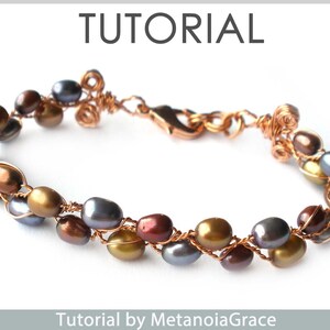 May include: A copper wire wrapped bracelet with a mix of brown, gold, and grey oval-shaped beads. The bracelet has a lobster clasp closure. Tutorial by MetanoiaGrace.