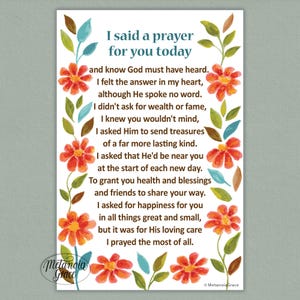 Può includere: Stampa rettangolare con il testo "I said a prayer for you today", circondata da fiori arancioni e foglie verdi. La stampa include una poesia e le parole "Metanoia Grace" in basso a sinistra.