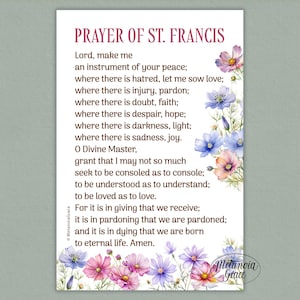May include: A decorative print featuring the "Prayer of St. Francis" in elegant script. The text is framed by watercolor floral illustrations in shades of pink, purple, and blue. The print includes the "MetanoiaGrace" and "Melancia Grace" logos.