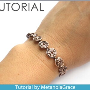May include: A copper wire bracelet featuring a series of coiled circles. The bracelet is worn on a person's wrist. Tutorial by MetanoiaGrace.