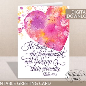 May include: Printable greeting card with a watercolor heart design. The card features the text "He heals the brokenhearted and binds up their wounds." with the scripture reference "Psalm 147:3". The card is designed by Metanoia Grace.