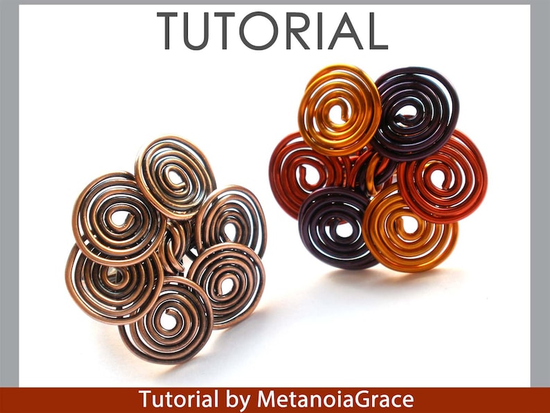 May include: Two wire rings with a flower design. The ring on the left is made of copper wire and has a brown colour. The ring on the right is made of multi-coloured wire and has a purple, orange, and red colour scheme. Tutorial by MetanoiaGrace.