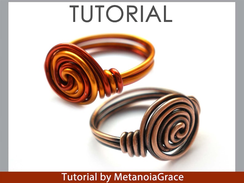 May include: Two wire rings with a spiral design. The top ring is made of copper wire in shades of orange and gold. The bottom ring is made of copper wire in a dark brown colour. Tutorial by MetanoiaGrace.