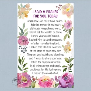 May include: A rectangular print with the text "I SAID A PRAYER FOR YOU TODAY" surrounded by watercolor floral illustrations in shades of pink, purple, and yellow. The print includes a poem and the artist's signature.