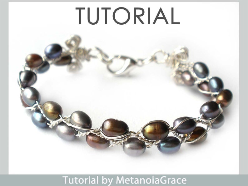 May include: A silver wire wrapped bracelet with a clasp fastening. The bracelet features a double row of dark grey, brown, and iridescent pearls.