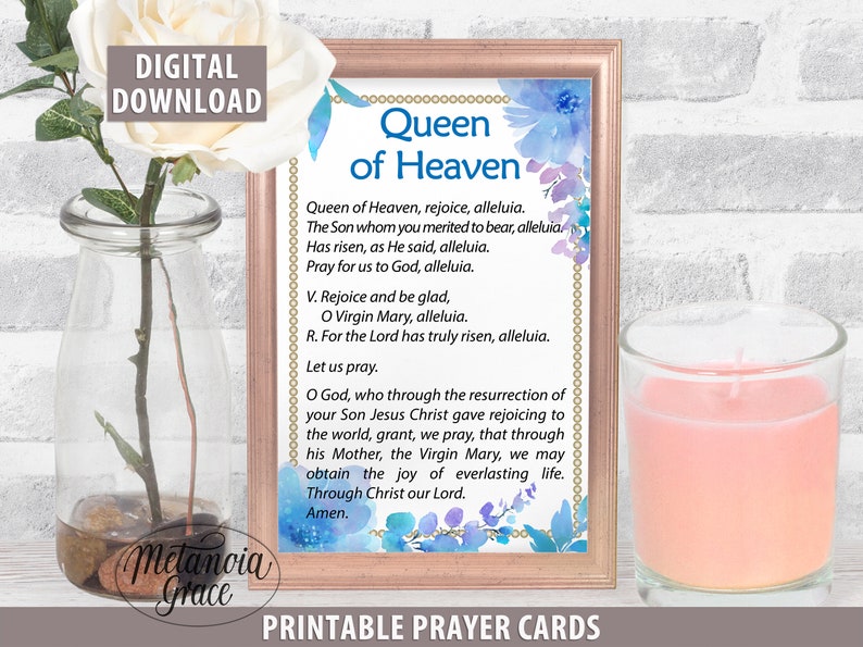 May include: Printable prayer card with a watercolor background featuring blue and purple flowers. The card features the text "Queen of Heaven" and a prayer to the Virgin Mary.