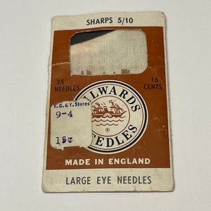 May include: Vintage package of "Sharps 5/10" needles, made in England. The brown and white card reads "25 needles" and "15 cents." The "Milwards Needles" logo features a ship. The package is slightly worn.