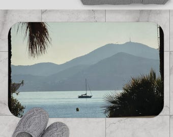 Sailboat in Cannes bay in France at Distant Mountains Bath Mat | Coastal Marina Seascape