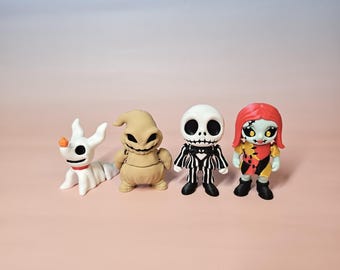 May include: Four figurines from the movie "The Nightmare Before Christmas" are displayed. The characters include Zero, Oogie Boogie, Jack Skellington, and Sally. The figurines are in a row on a pink surface with a gradient blue and pink background.