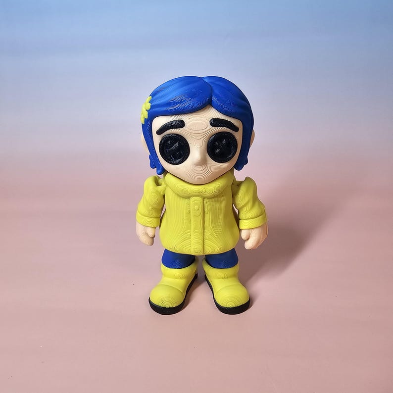 May include: A figurine of a character with blue hair, button eyes, and a yellow coat. The figure is wearing blue pants and yellow boots. The figurine is standing on a pink surface with a blue and pink gradient background.