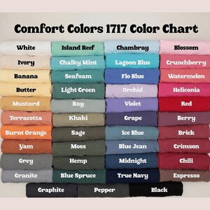 May include: A color chart titled "Comfort Colors 1717 Color Chart" displays a variety of fabric colors. The chart includes shades like white, ivory, banana, butter, mustard, terracotta, burnt orange, yam, grey, and granite.