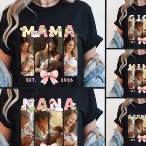 May include: Black t-shirt with the word "MAMA" in a floral design, featuring photos of a mother with her baby, a pink bow, and the text "EST. 2026". Other shirts say "GIGI", "MIMI", "NANA", and "GRANDMA".